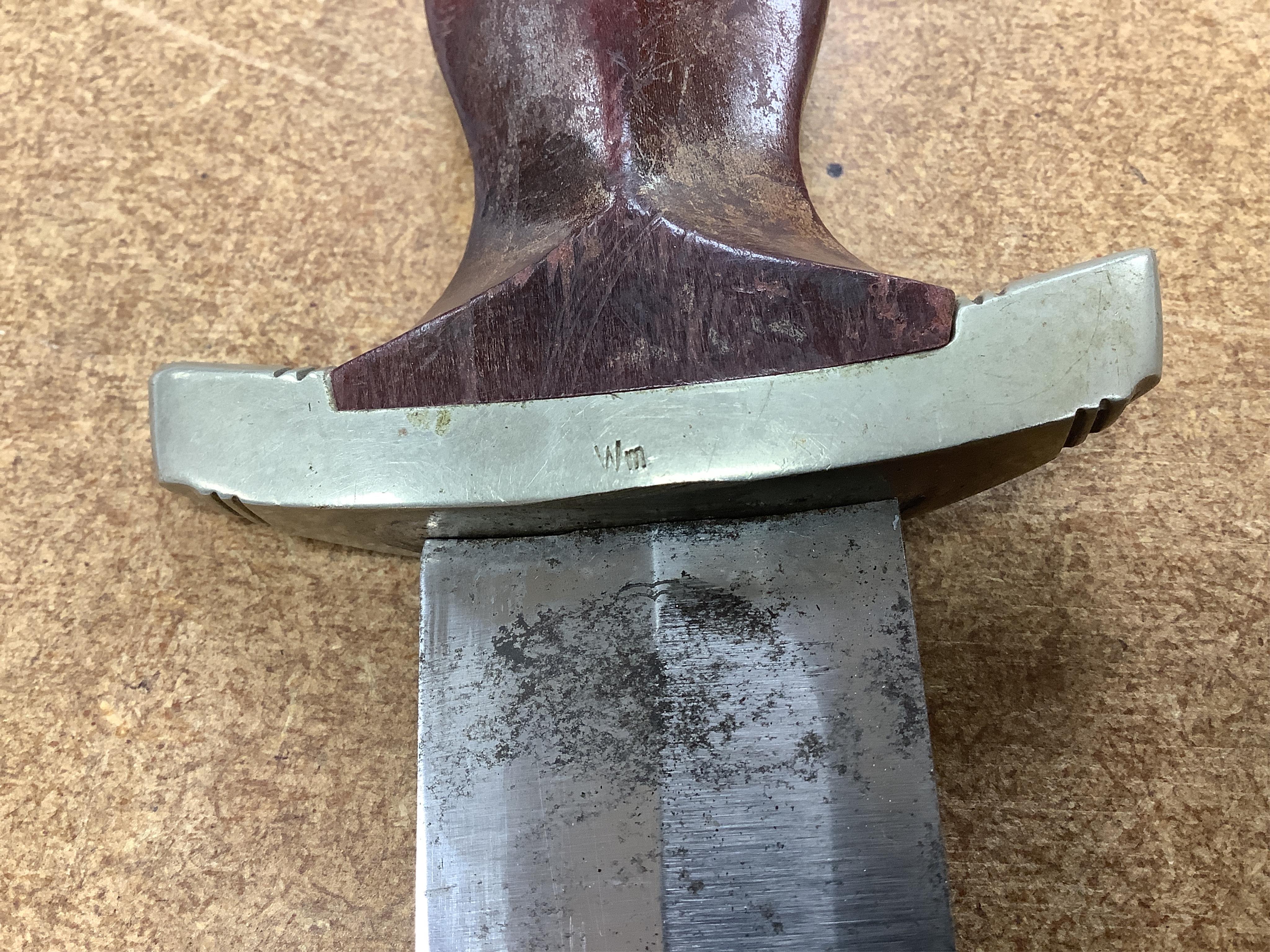 A WWII German SA dagger, regulation pattern in its steel scabbard with regulation nickel mounts, and leather hanging band and a German dress bayonet by Paul Seilheimer. Condition - fair, some wear